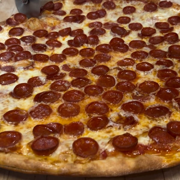 A close-up of a freshly baked Allegro Pizza pepperoni pizza with melted cheese and a golden crust.